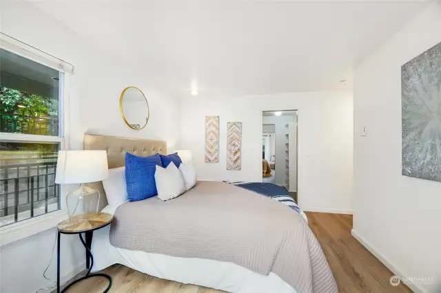 A view into the spacious walk-in closet and entry to the en-suite bathroom.