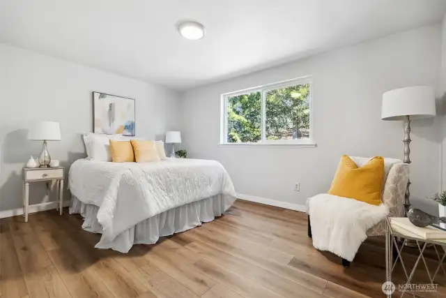 Primary bedroom looks out to beautiful backyard