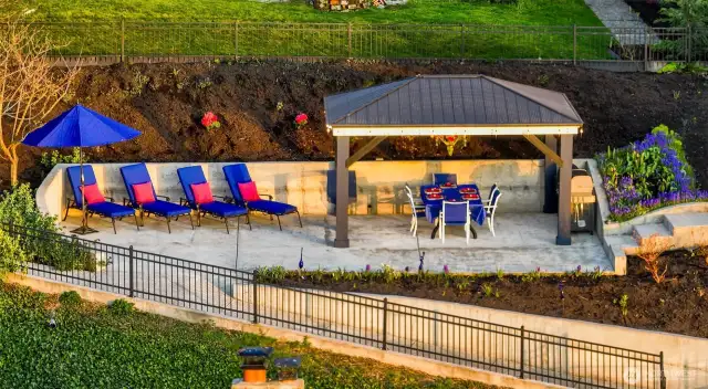 At the top of the walk, a hidden world reveals itself—sun-drenched loungers, a shaded pavilion, and the sweet scent of freshly turned soil rising from the flowerbeds. Whether it’s morning coffee in solitude or sunset cocktails among friends, this upland terrace feels like the final page of a love letter to Puget Sound.