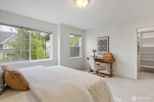 Large-sized Guest Bedroom with a walk-in closet and closet system.