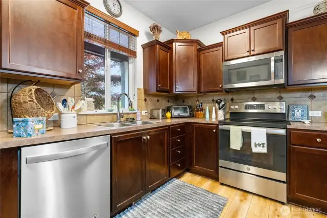 Dark cabinetry, stainless appliances