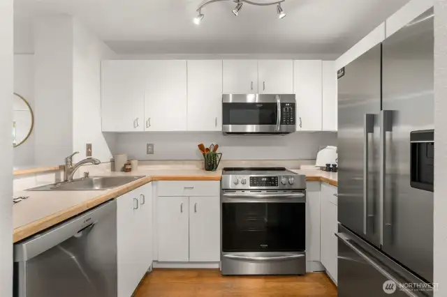 Kitchen has white cabinetry