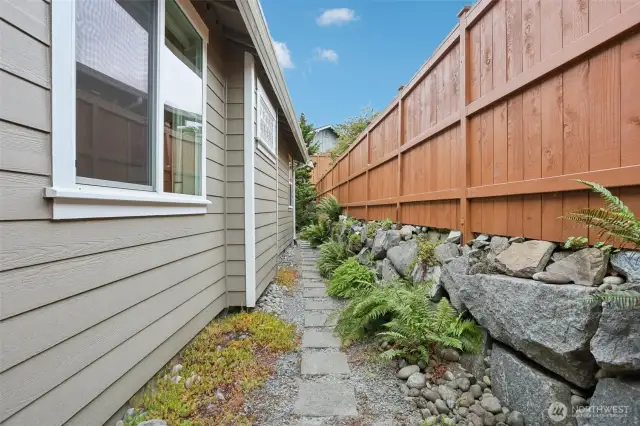 Walkway on the south side of the house leading you to the backyard. Gate is by front door. NEW FENCE!!!