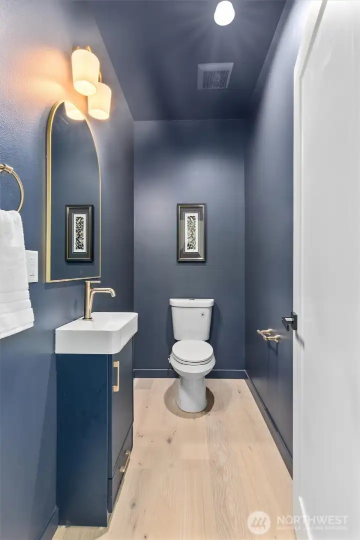 Powder room just off living room, near garage entrance.