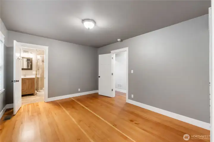 Primary bedroom with view of bath entry.