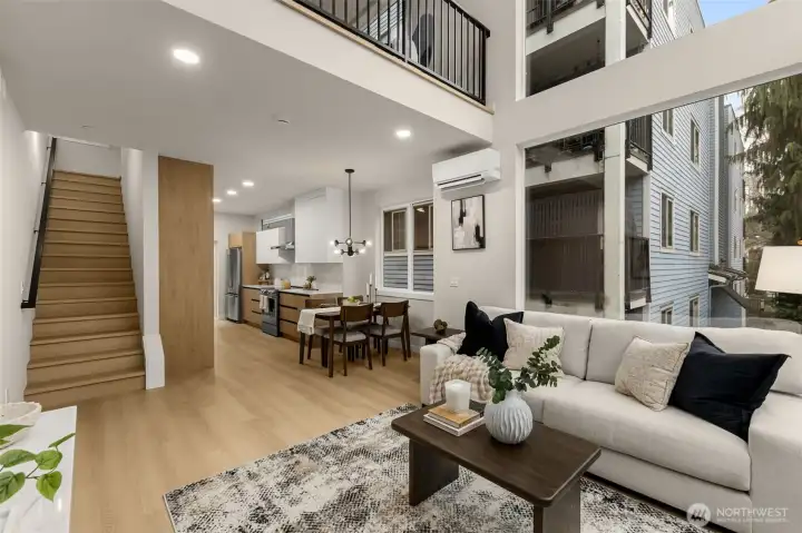 The dining room opens into a a spacious and bright living room with a large loft overlooking  the space below.