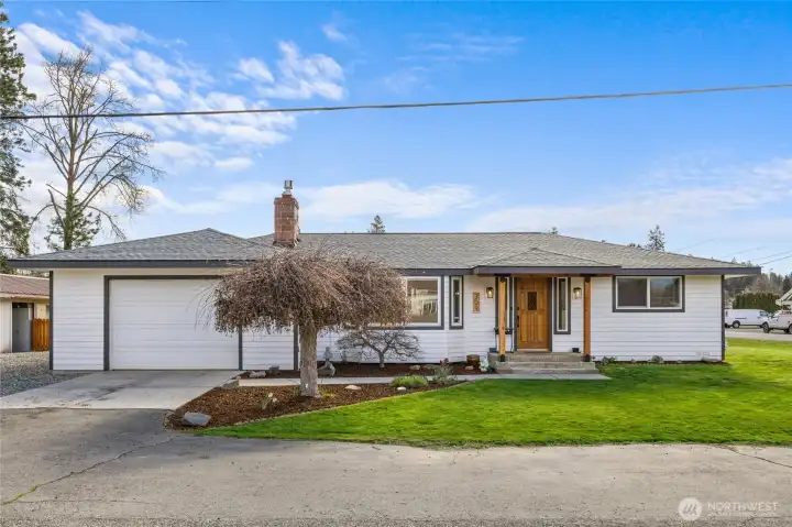 Large corner lot with better than new home.