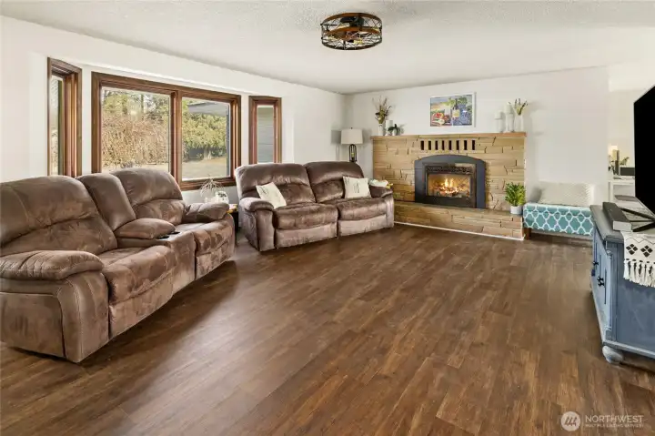 New wood wrapped windows in the home with the new floors look so nice and fresh. You can have a cozy fire on those winter days.