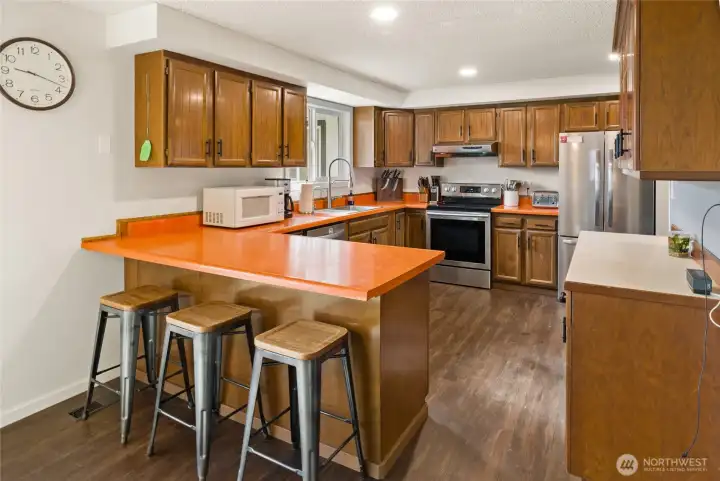 Tons of cabinet space it this large kitchen. The side island or peninsula creates lots of extra eating or serving space.