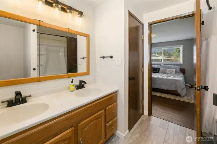 New lighting and large mirror make this primary restroom so nice to use. Not to mention the new floors. Like I said this home is better than new!