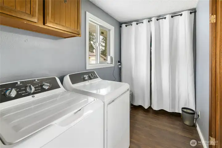 Considerate size laundry room with cabinets & a new window to allow some natural light.