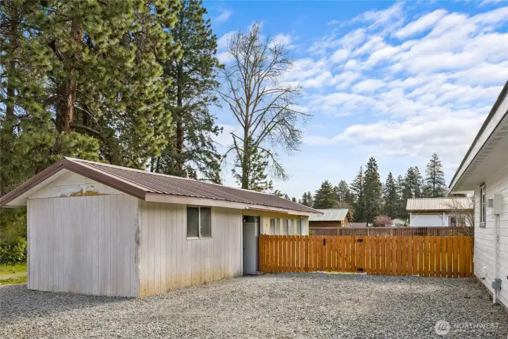 There is a large utility shed that has entrances on the front side of the fencing as well as the back yard for easy access. Look at the extra parking at this home. So much space!