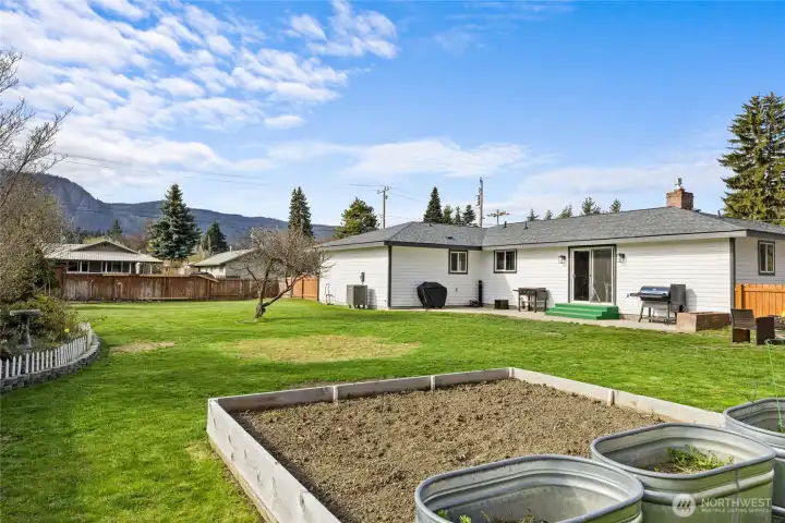 Another view of the massive back yard. On this side of the yard is a veggie garden to enjoy some fresh vegetables or maybe a flower garden.