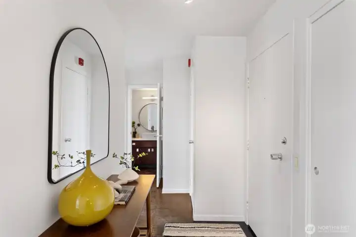 Spacious entry with coat closet and linen cupboard flanking the front door. Ample space for an entry table.