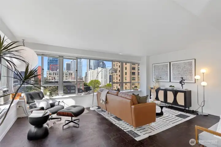 Expansive windows capture sweeping city views and fill the open layout with abundant natural light.