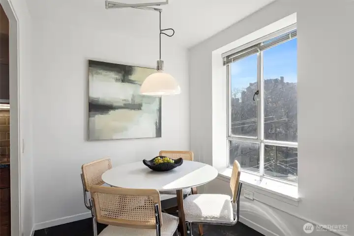 Dining area - Convenient area off the kitchen and great flow into the living area. More views of the city from here. Modern chandelier accents this space.