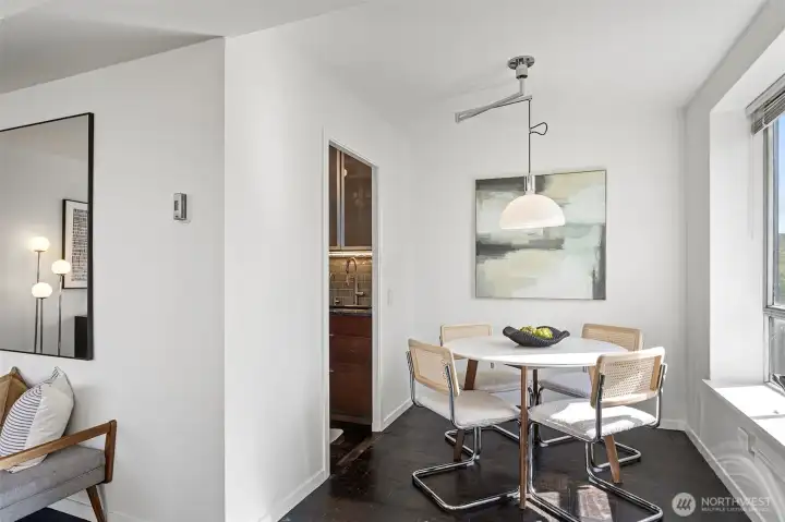 Dining area - Convenient area off the kitchen and great flow into the living area. More views of the city from here. Modern chandelier accents this space.