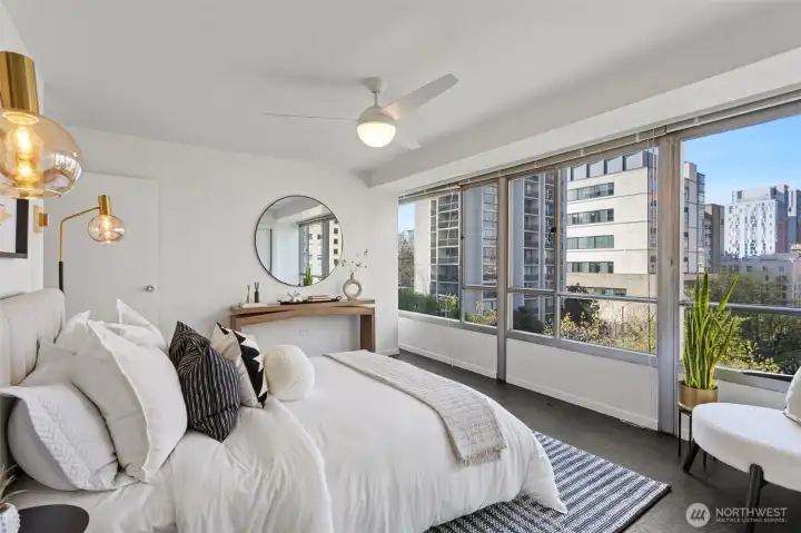 Primary bedroom —Plenty of space for extra seating in this room to enjoy the stunning west view! Extra cooling with a modern ceiling fan and lots of closet space with a hidden safe.
