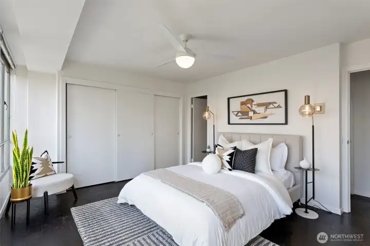 Primary bedroom —Plenty of space for extra seating in this room to enjoy the stunning west view! Extra cooling with a modern ceiling fan and lots of closet space with a hidden safe.
