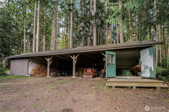 The covered shed is perfect for storage of tractors, firewood and has two large storage spaces complete with electricity. The covered shed is perfect for storage of tractors, firewood and has two large storage spaces complete with electricity.