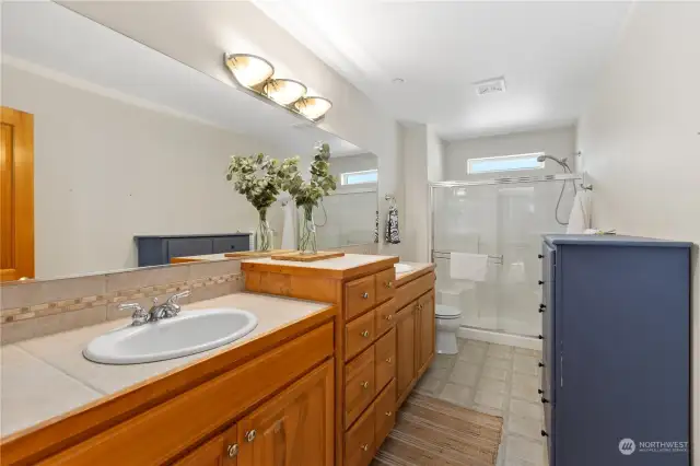 Primary ensuite bath features a grand vanity with extra storage and double sinks.