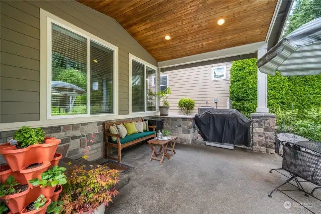 Relax on the covered backyard patio, featuring a dedicated gas BBQ line and granite prep counter, perfect for outdoor dining and entertaining.