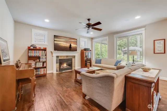 Gather in the inviting family room, complete with a gas fireplace and large windows overlooking the backyard.