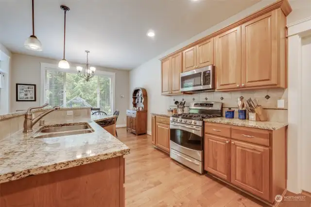 Cook and entertain in this gourmet kitchen, featuring granite countertops, stainless steel appliances, and ample cabinetry.