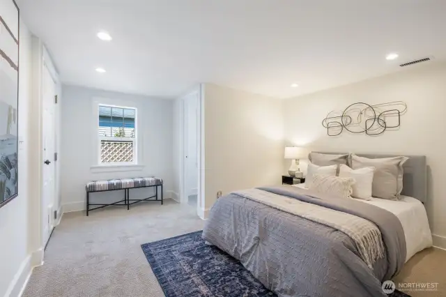 One of the three lower level bedrooms with ensuite 1/2 bath
