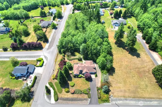 This 2.3 acre corner homesite offers space and privacy in desirable neighborhood