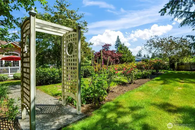 Breathtaking landscaping with rose garden, mature trees, perennials and scrubs that have been meticulously maintained and enjoyed in this fully fenced private backyard.
