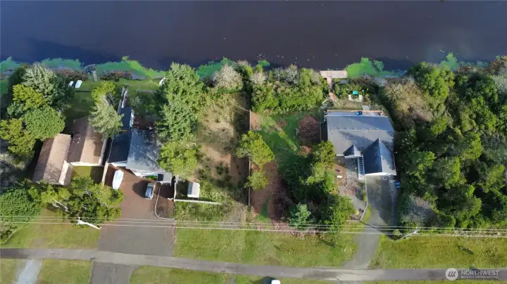 Partially cleared but still has privacy buffer. Fenced on one side