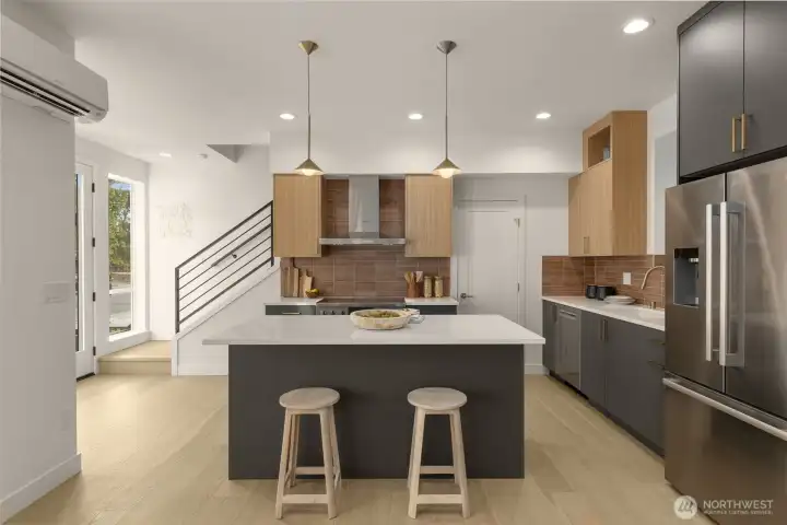 With a waterfall-edge island and rich wood tones, this kitchen stuns from every angle.