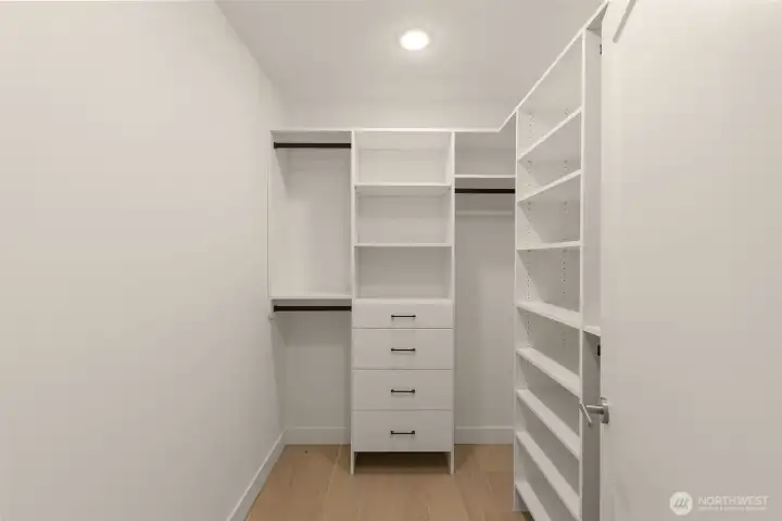 Storage meets serenity in this walk-in wardrobe built for organization and ease.