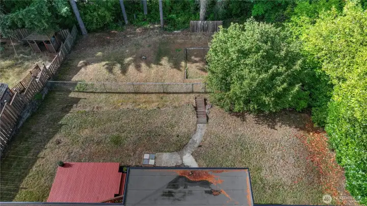 This yard is a blank palette just waiting for you…there is an old sand area on the lower level that could be used for a fire pit or sand volley ball court or a badmitten net…