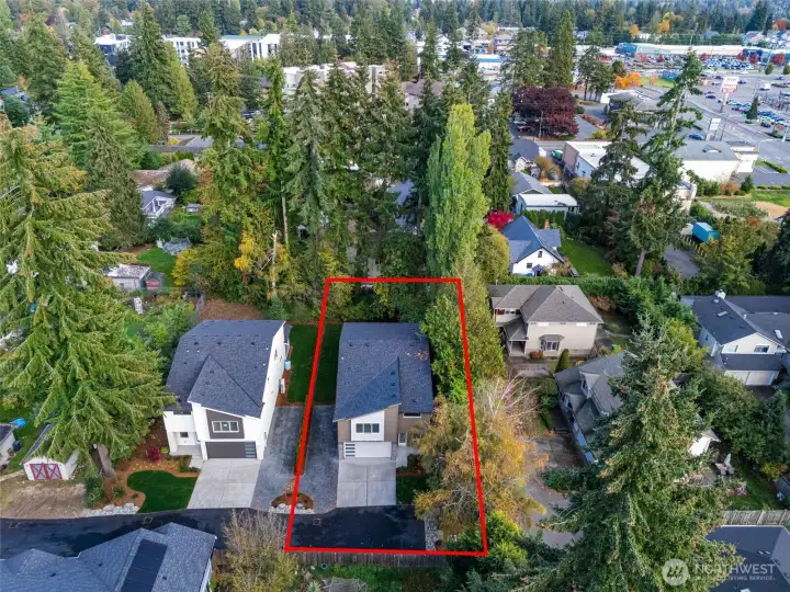 This oversized lot extends beyond the tree line to the rear white fence, offering a rare blend of privacy and highly usable outdoor space — ideal for entertaining, custom landscaping, or future additions — all complemented by RV parking for boats, campers, and every lifestyle upgrade.