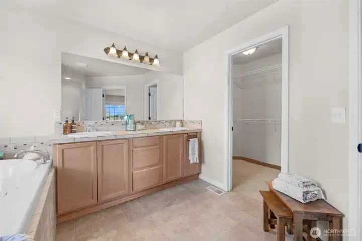 Primary five piece bathroom with first walk in closet.