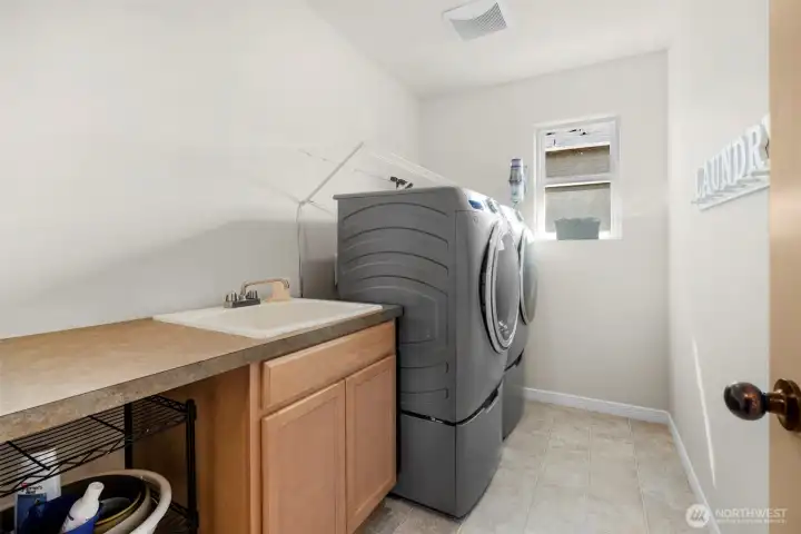 Laundry room with extra storage and sink (upstairs).