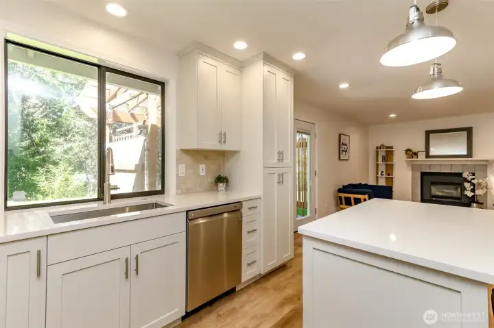 Large SS sink overlooks beautiful backyard.