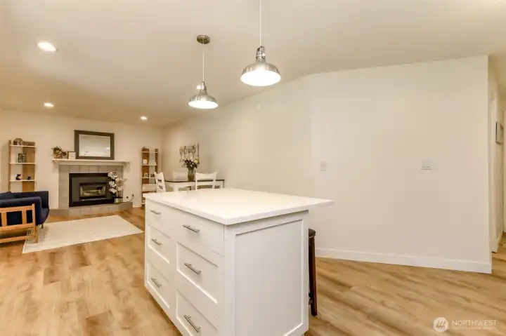 Kitchen facing dining room and living room with gas fireplace.