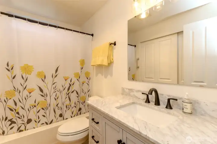 Remodeled bathroom with tub & shower.