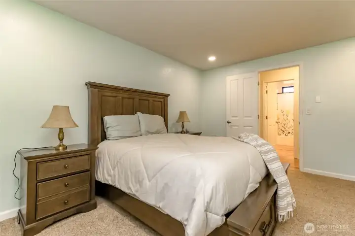 Primary bedroom across the hallway from the full bathroom.