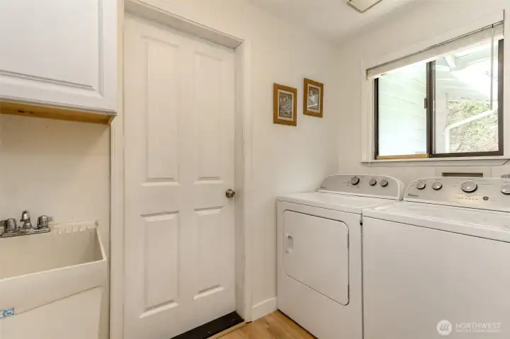 Utility room with deep basin utility sink. The door leads to the two car garage.