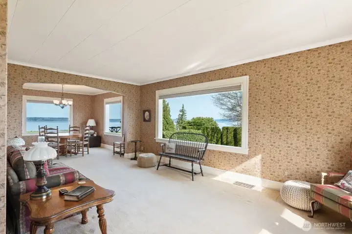Living Room open to Dining Room both with large windows to capture the gorgeous water & mountain views.