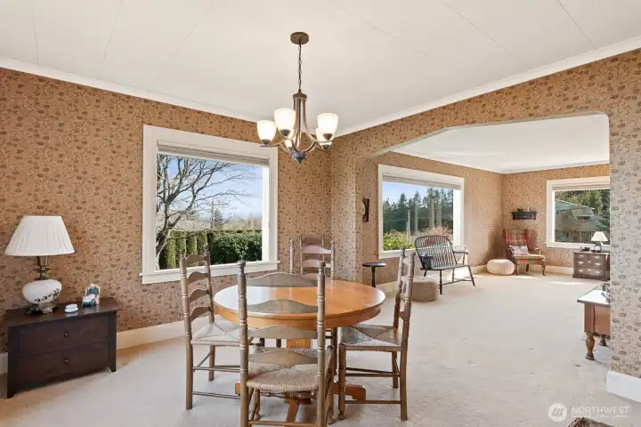 Dining room open to living room by charming arch