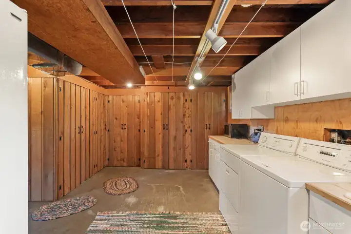 Basement with tons of built in storage and laundry area with folding counter
