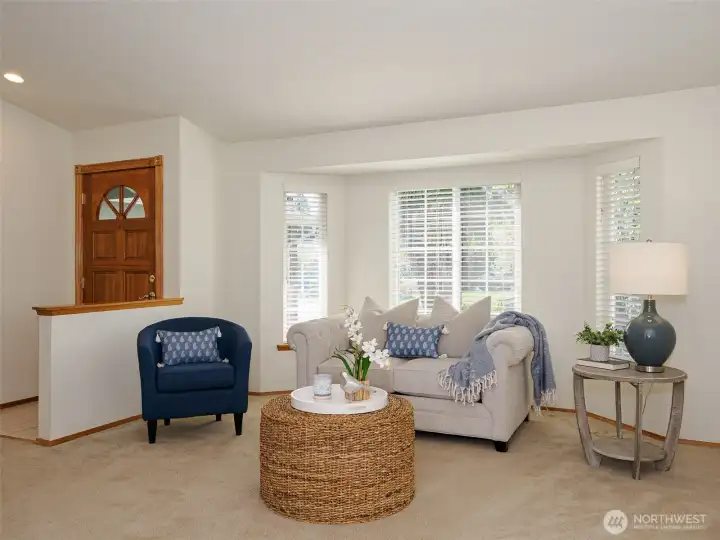 Large living room is bathed in natural light.