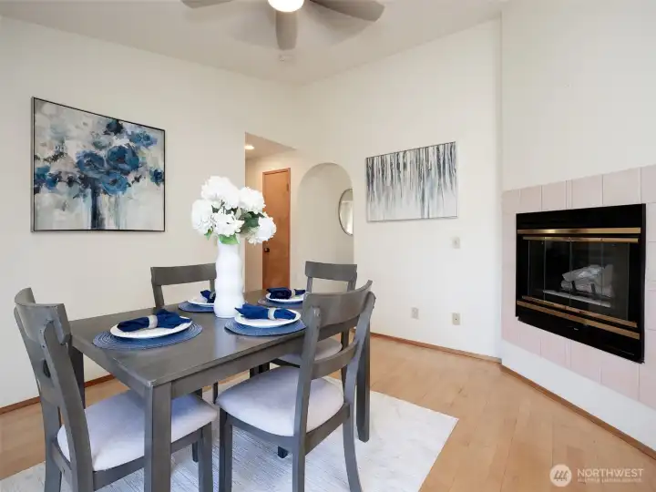 Through the arches, enter into the breakfast nook with cozy fireplace for cooler days.