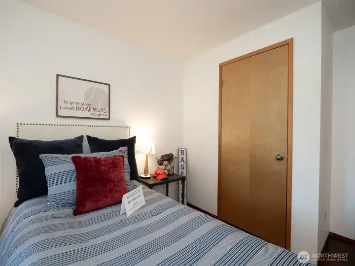 The second bedroom with laminate flooring.