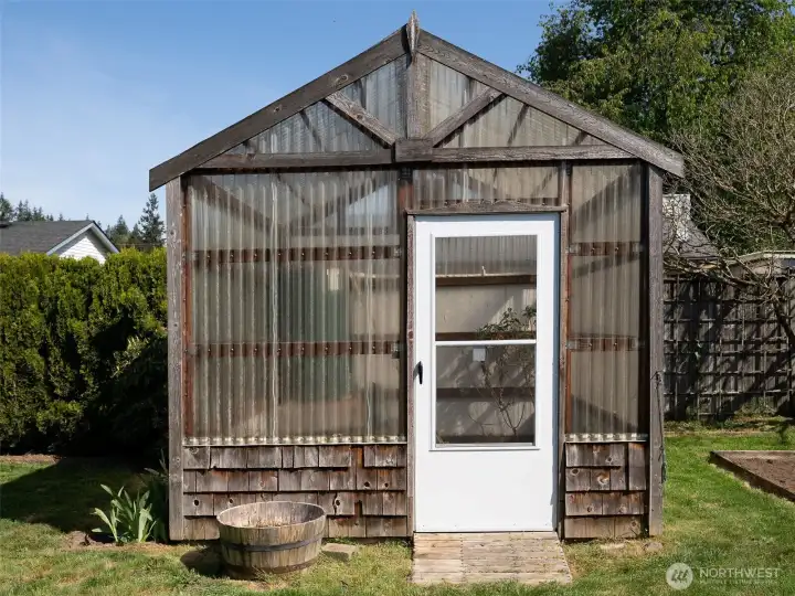Cute and functional greenhouse with new door.